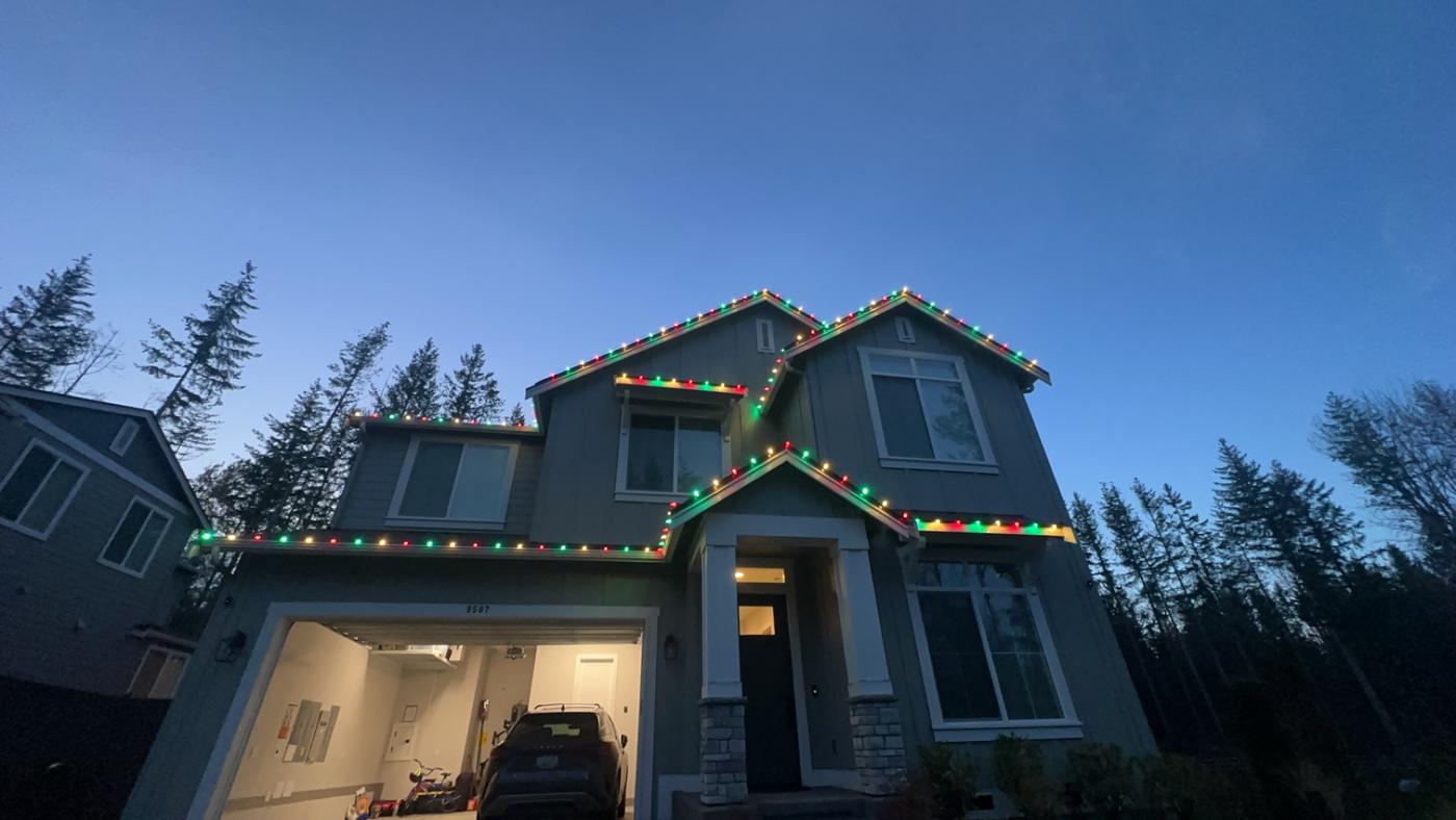 Red, green and warm white lights at dusk