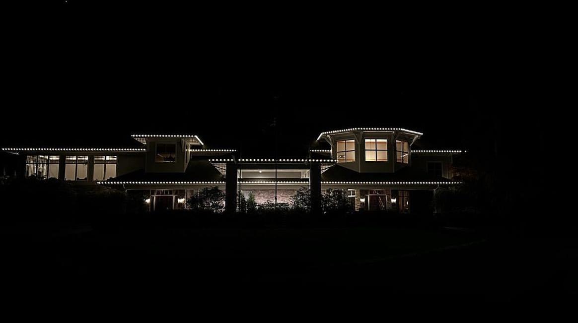 Large home outlined in warm white lights