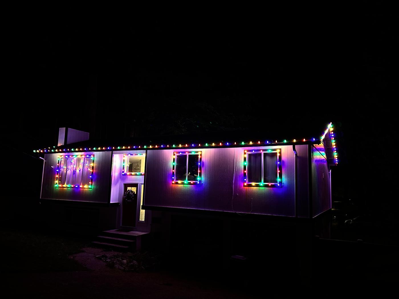 Single-story home with multicolor roofline and window lights