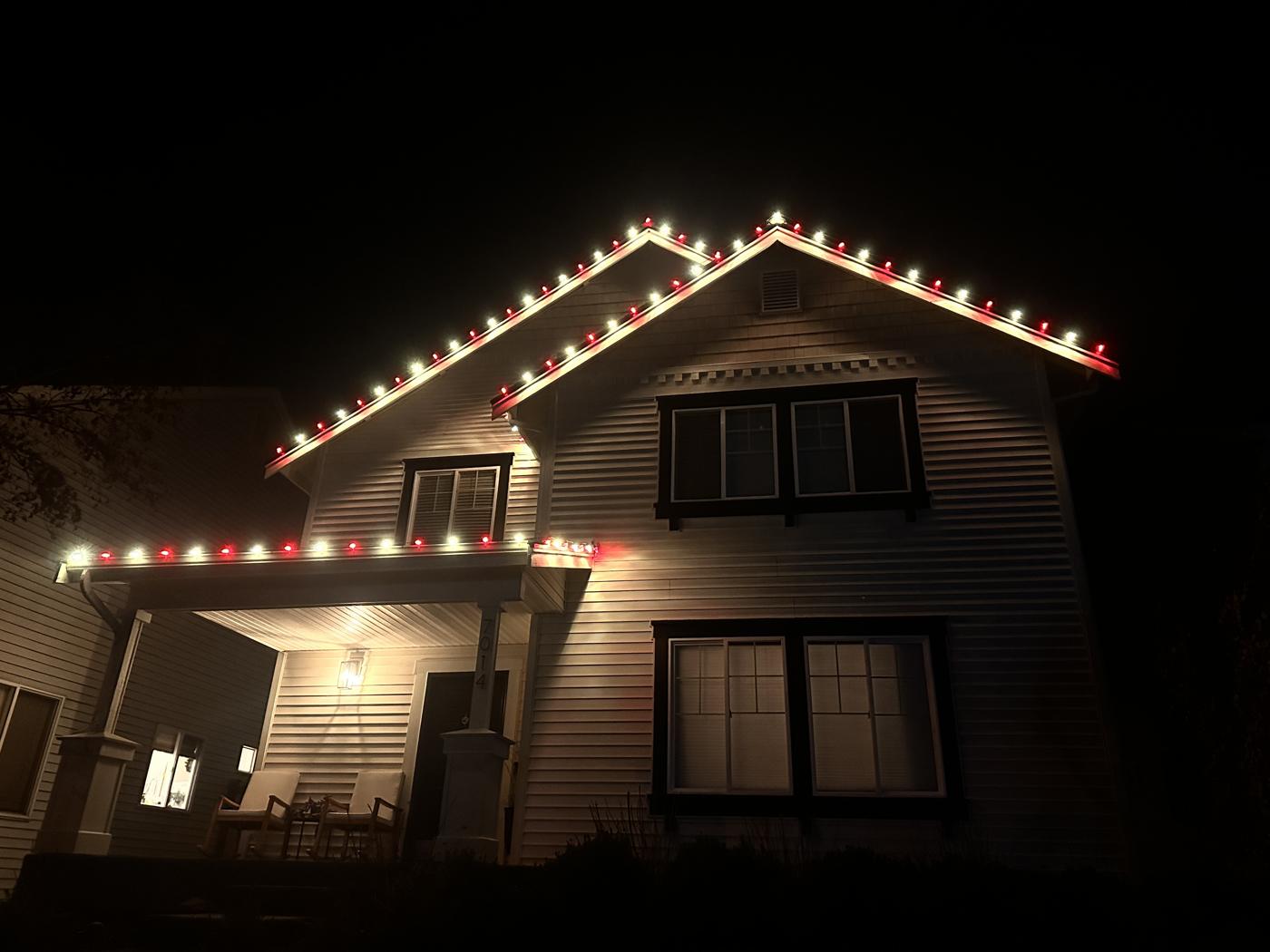 Red and white C9 lights on a gable roof