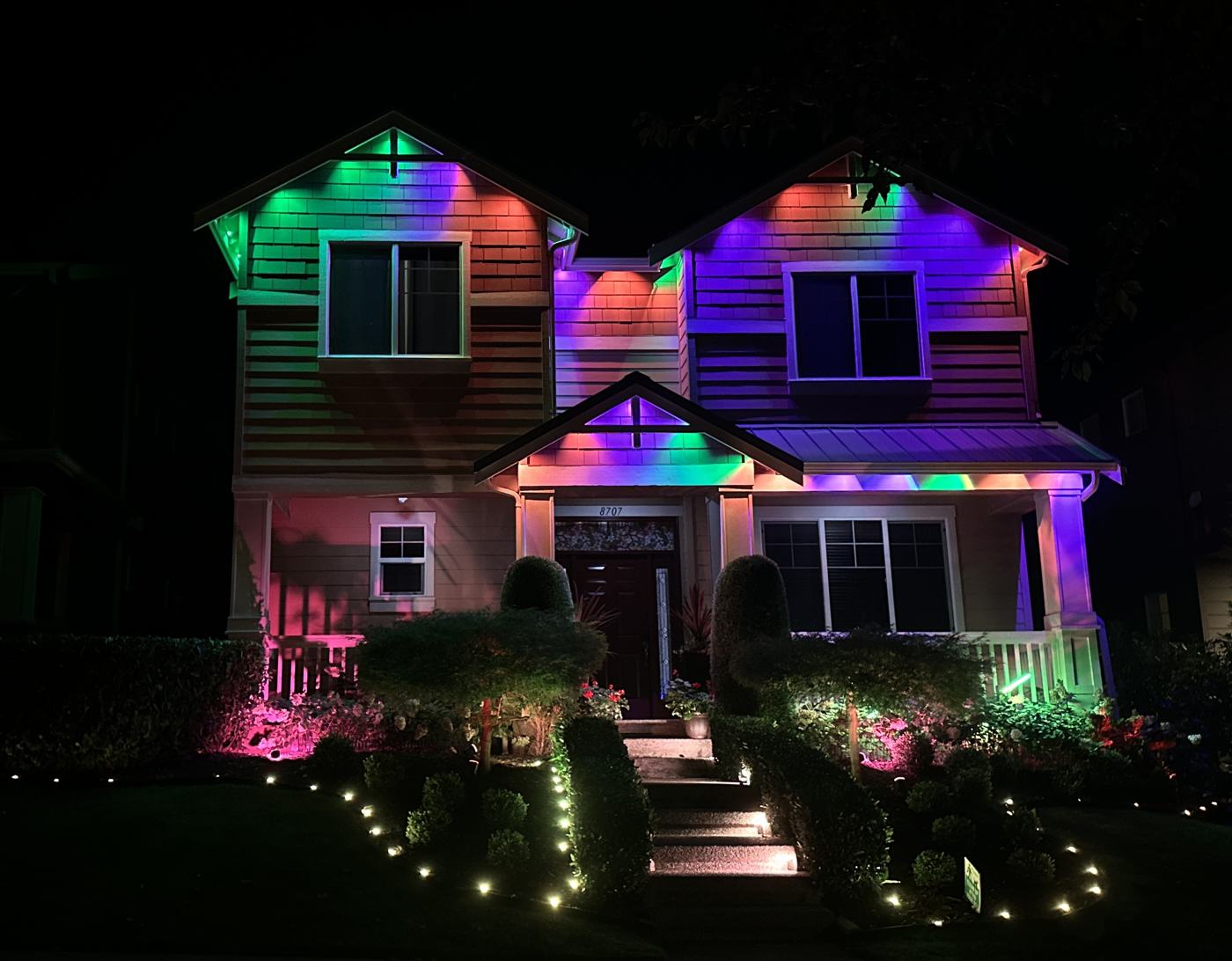 Two-story home with Govee permanent lights in green, orange and purple