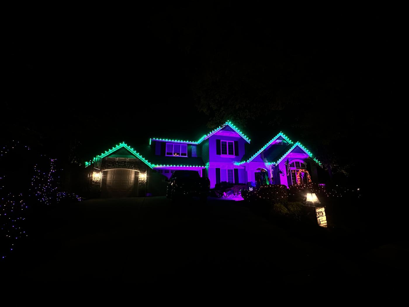 Home lit teal and purple for Halloween