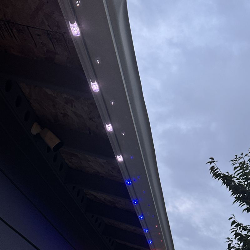 Close-up of Minleon lights mounted in a track under the gutter