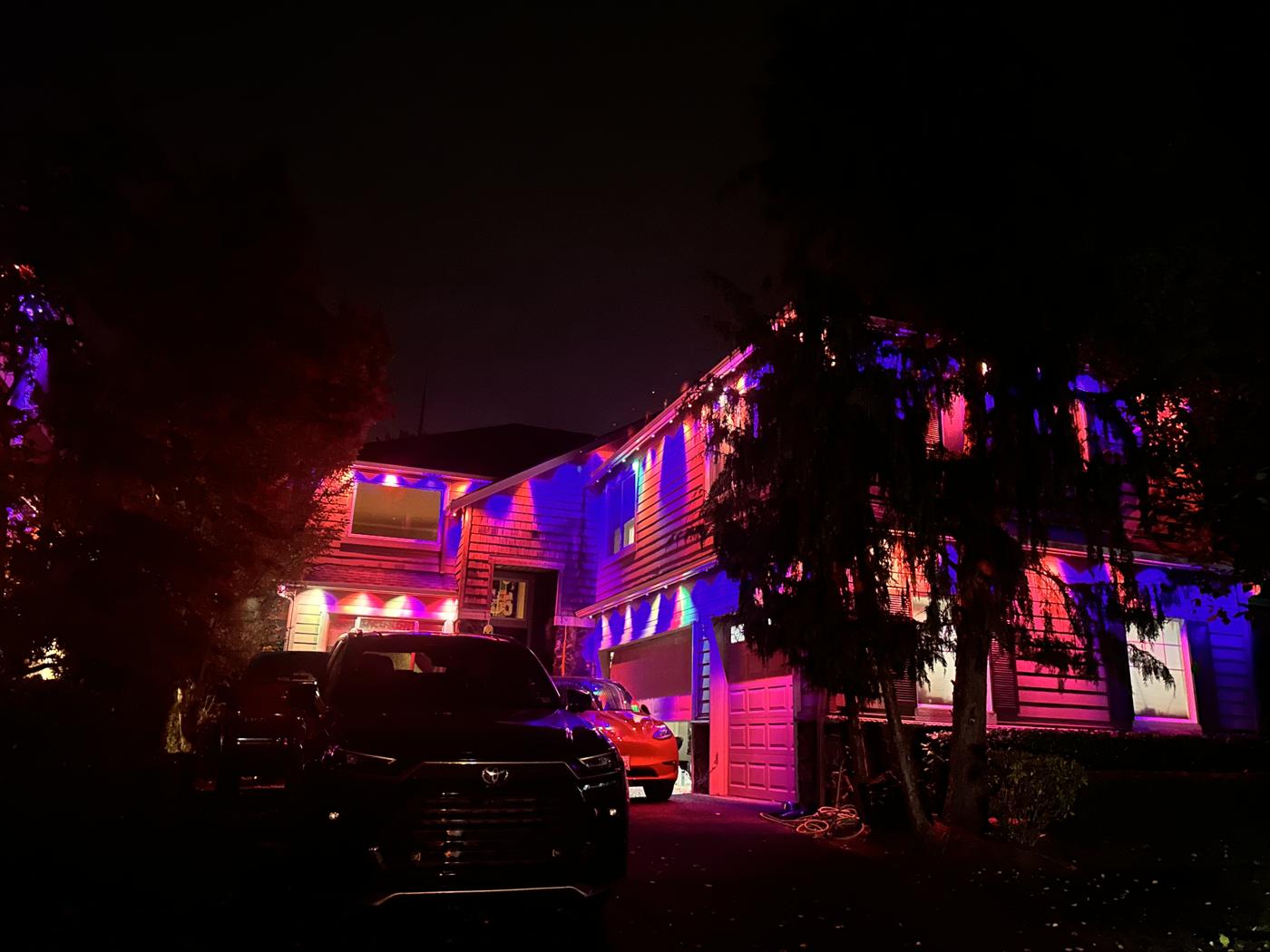 Govee permanent lights washing a home in pink and purple
